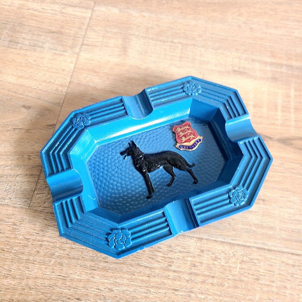 Guernsey metal ashtray with dog design.